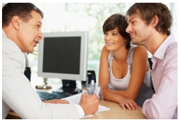 Three people discussing a document