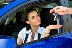 Girl in car being handed keys