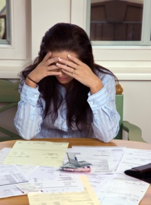 Woman with table full of bills