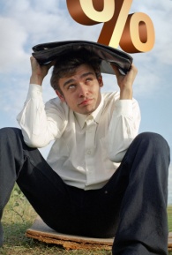 Man under a heavy percentage sign