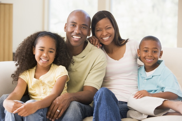 Family sitting on couch together